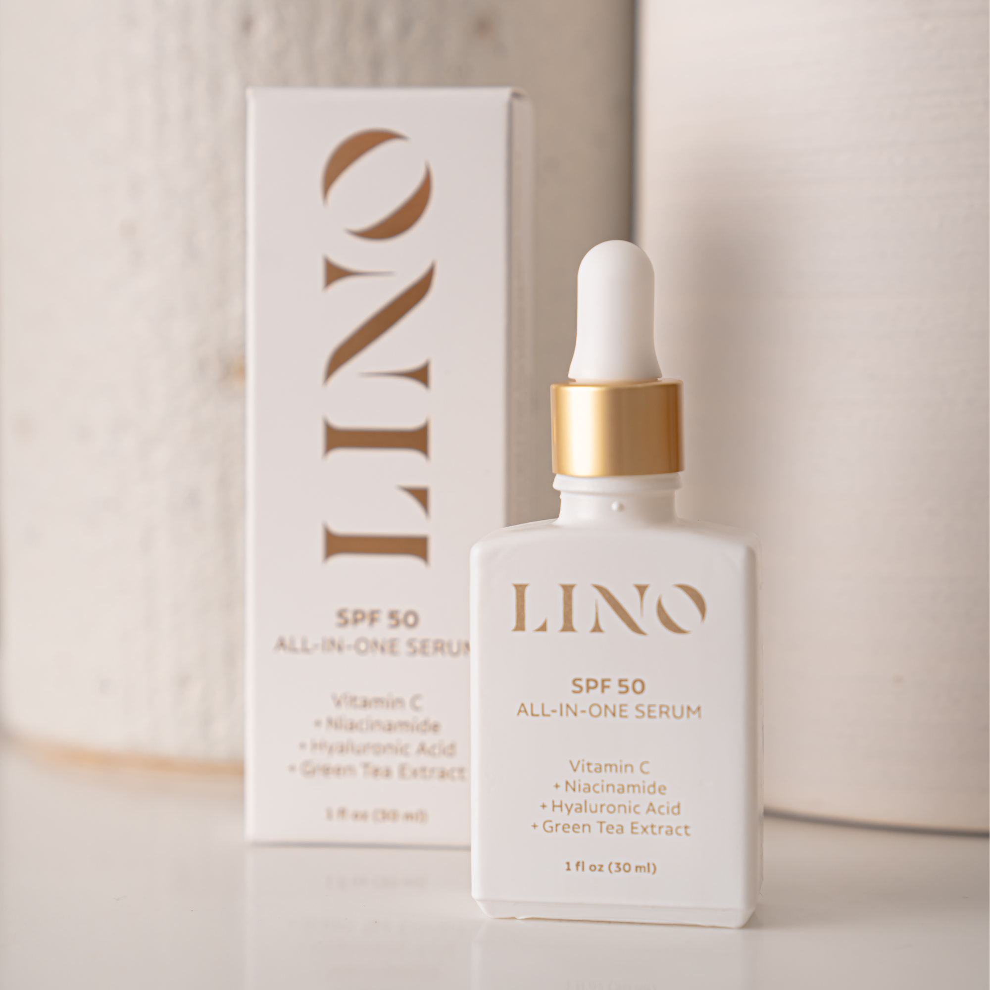 All-in-one face serum with SPF 50 and vitamin c in a sleek minimalist pump bottle.