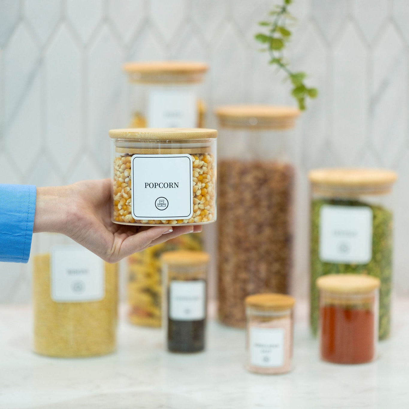 Round clear borosilicate glass storage jar with a natural bamboo airtight lid for pantry organisation.
