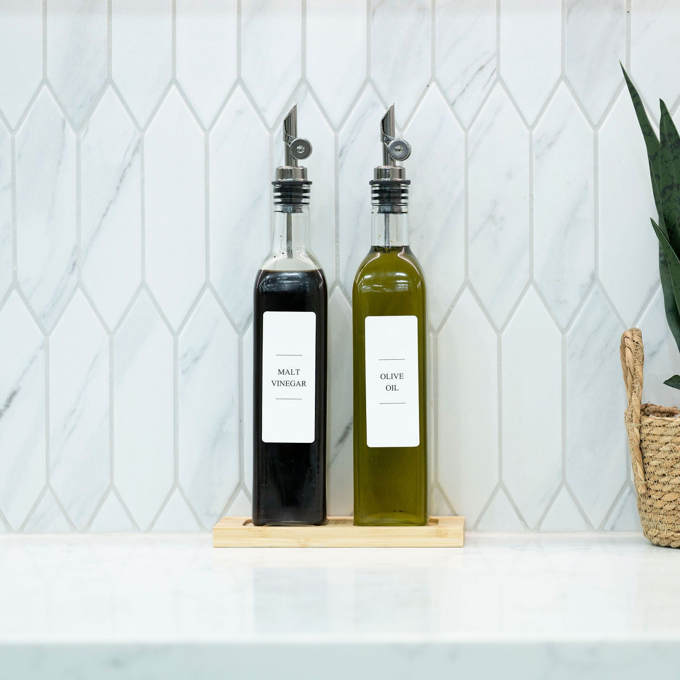 Two 500ml clear glass oil and vinegar bottles with metal pourers on a natural bamboo tray — view 5