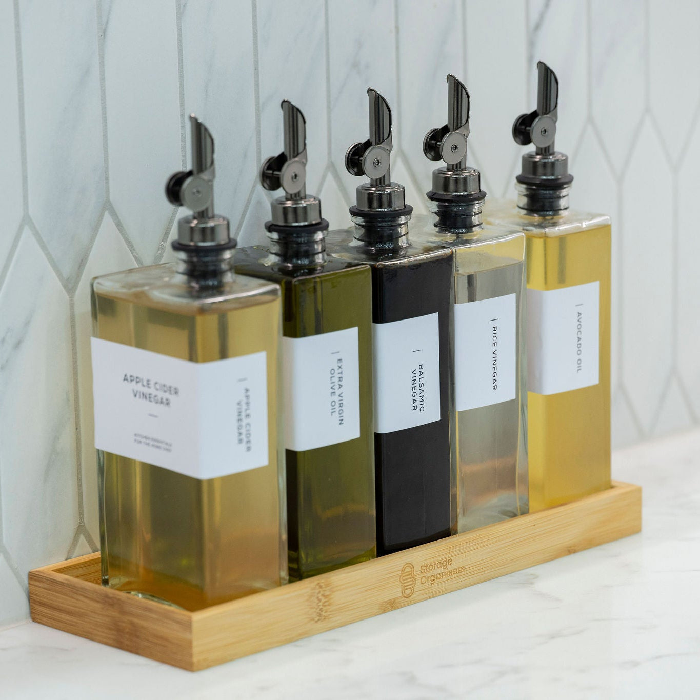 5-piece clear glass oil and vinegar bottle set with precision pourers on a natural bamboo tray — view 2