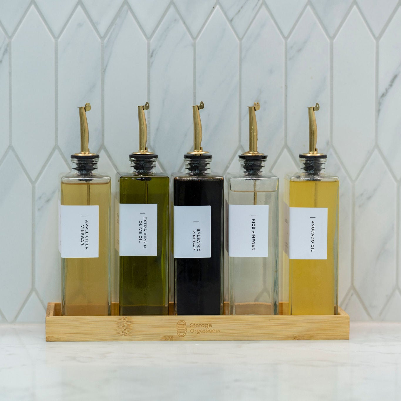 5-piece clear glass oil and vinegar bottle set with precision pourers on a natural bamboo tray — view 3