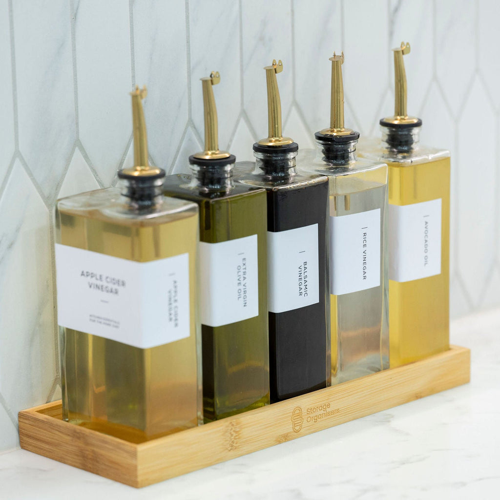 5-piece clear glass oil and vinegar bottle set with precision pourers on a natural bamboo tray — view 4