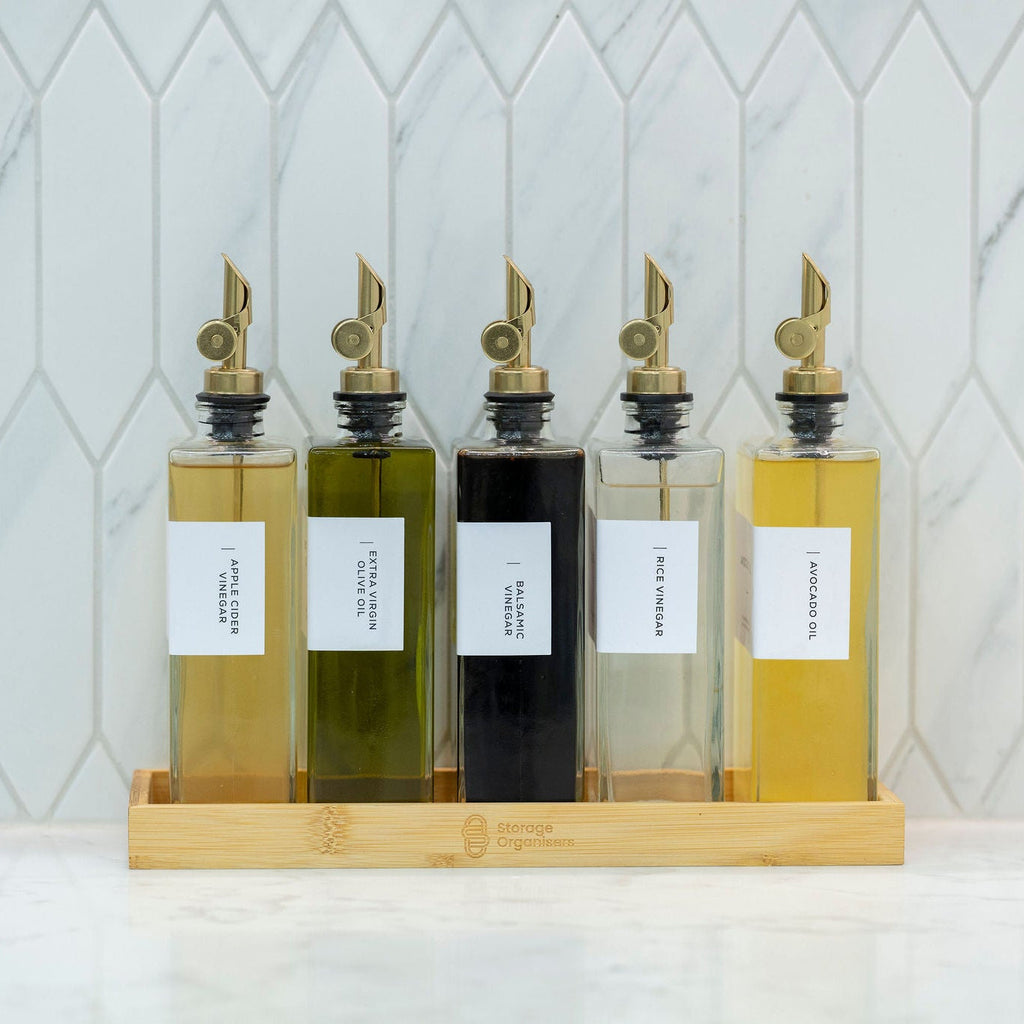 5-piece clear glass oil and vinegar bottle set with precision pourers on a natural bamboo tray — view 5