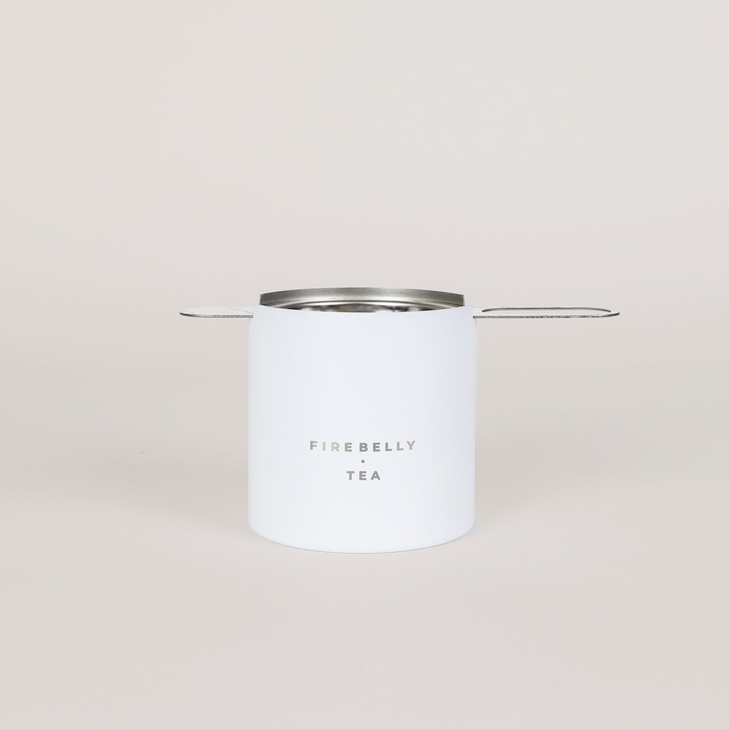 Black loose leaf tea strainer and fine mesh infuser resting on a matching catch cup. — view 4