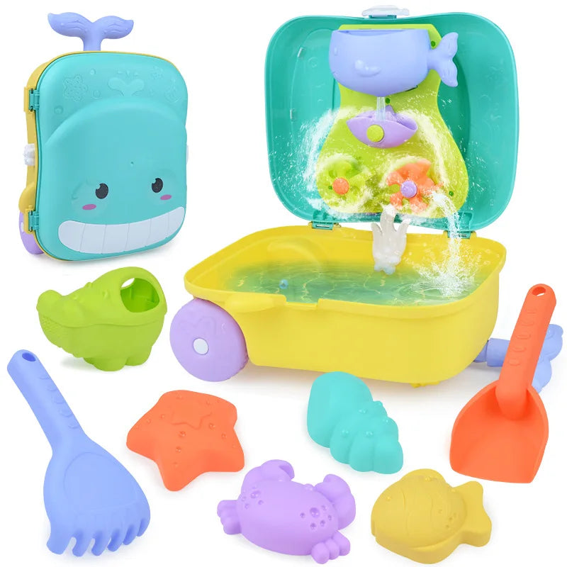 Kids beach sand play kit with whale themed rolling luggage, bucket, shovel, and sea creature molds