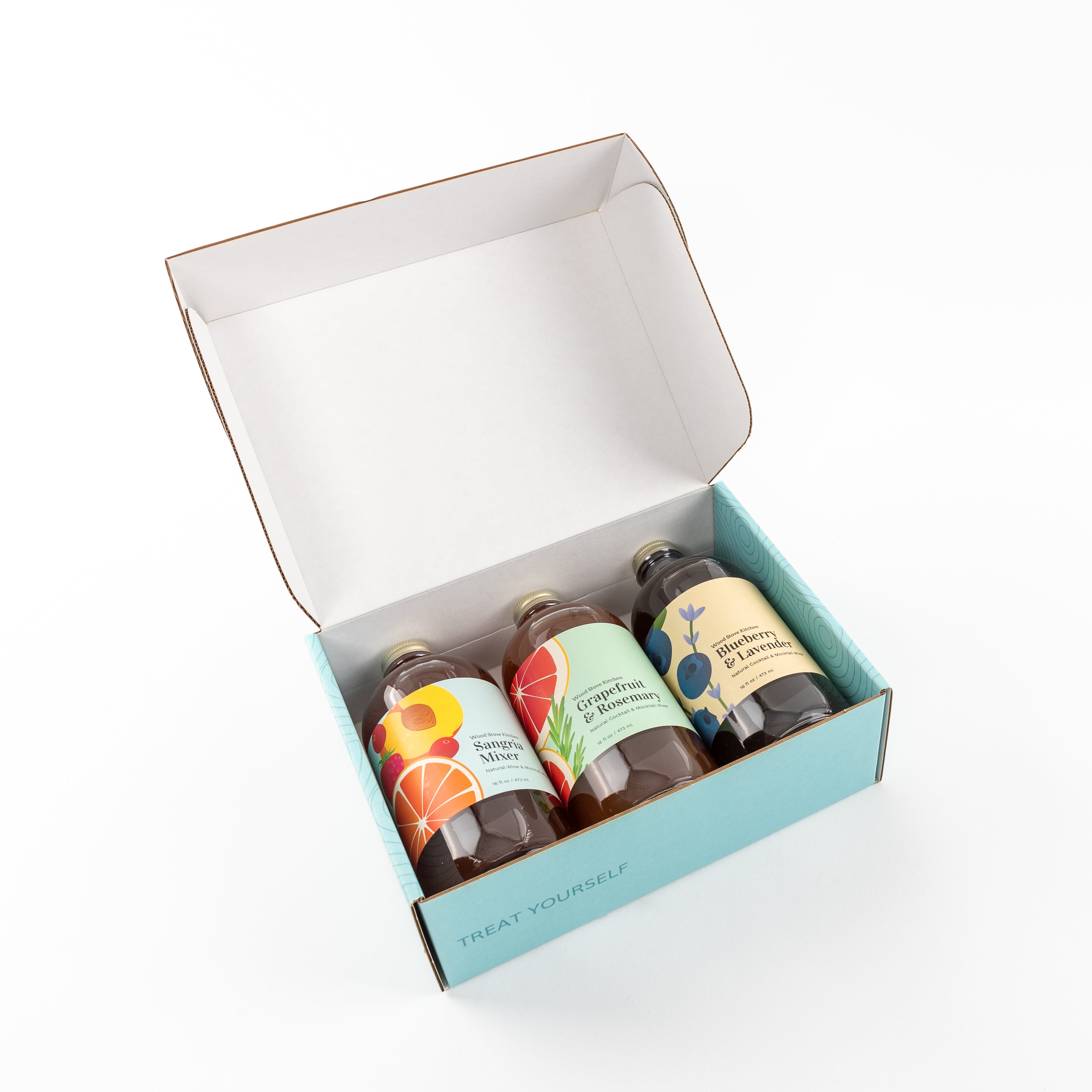 Three bottles of summer cocktail mixers in a gift box featuring sangria and grapefruit flavors — view 5