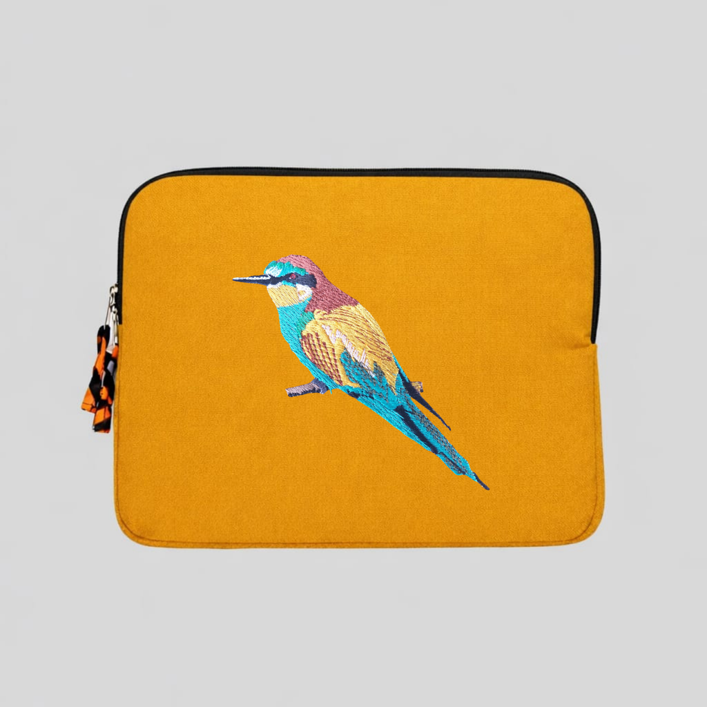 Bee eater laptop sleeve crafted from cotton canvas featuring detailed bird embroidery in earthy colors.
