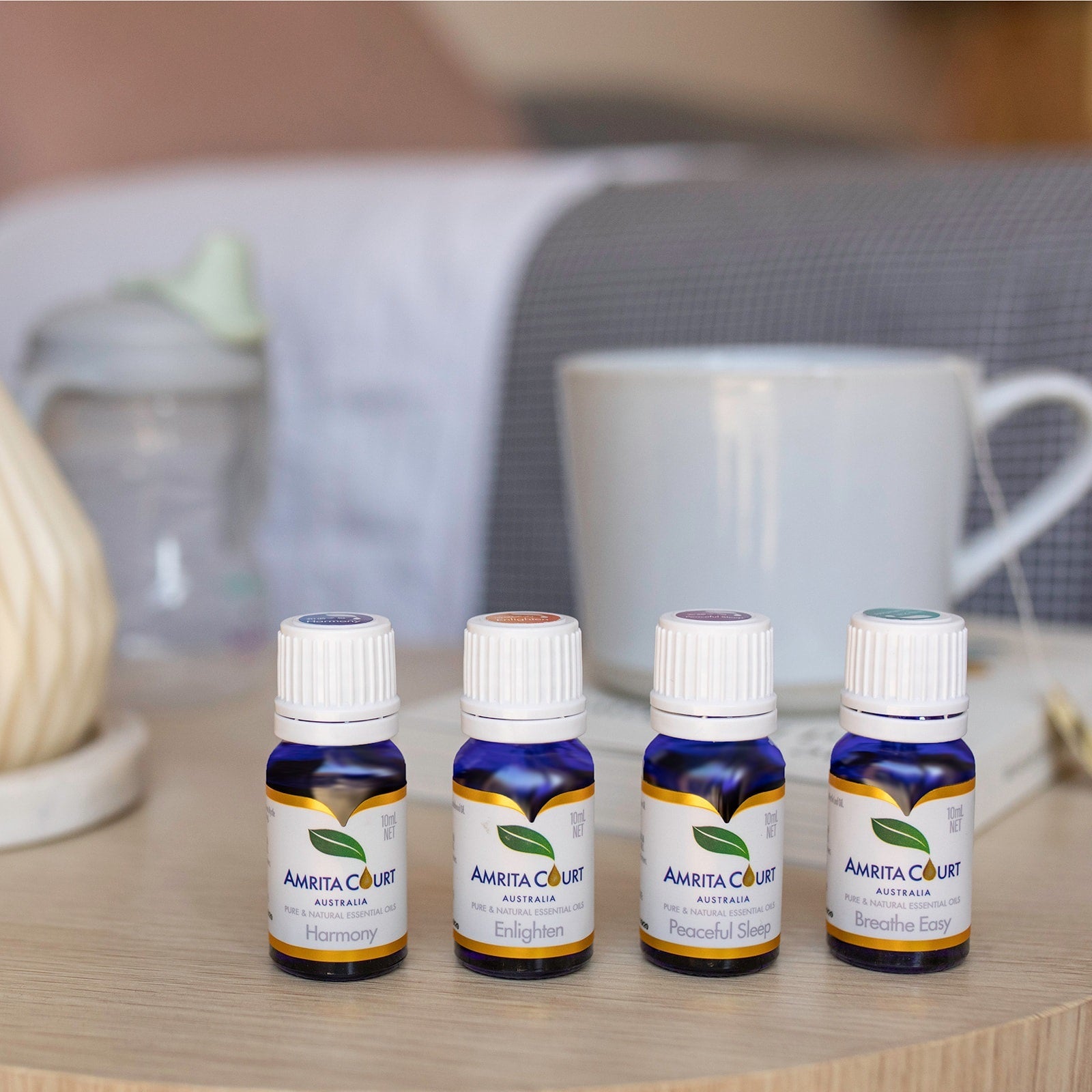 Amrita Court Full Spectrum Ritual Bundle featuring four amber glass essential oil bottles for aromatherapy