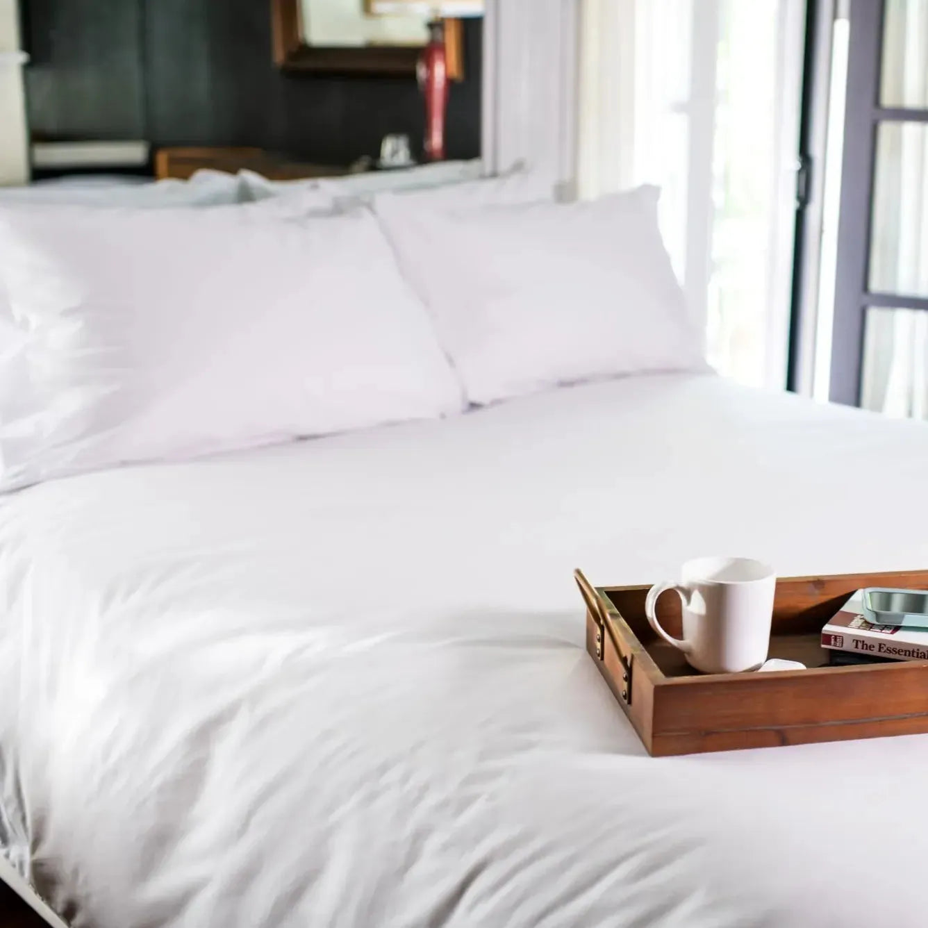 Folded stack of crisp T-300 white combed cotton bed sheets with matching pillowcases — view 4