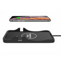 Black silicone 15W wireless car charger and phone cradle for Apple and Android smartphones on dashboard