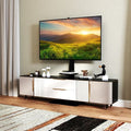 Black adjustable floor TV stand with built in power outlet, media shelves, and flat screen