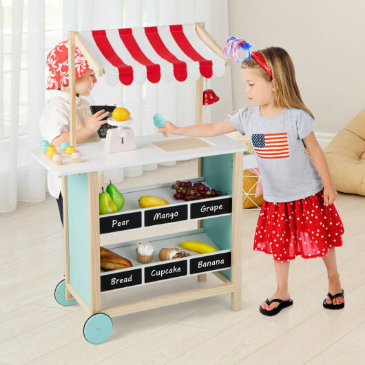 Red wooden kids ice cream cart toy with handle, wheels, chalkboard, and display shelves. — view 2