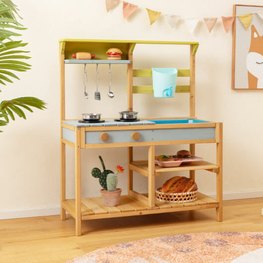 Outdoor kids mud kitchen in natural fir wood with working water faucet, sink, and storage shelves