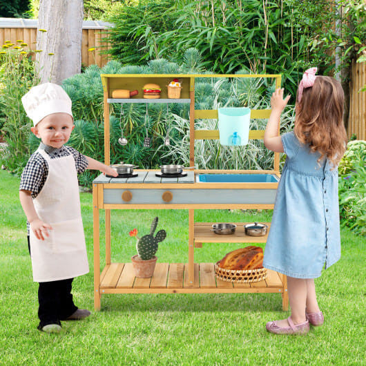 Outdoor kids mud kitchen in natural fir wood with working water faucet, sink, and storage shelves — view 2
