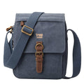 Medium stonewashed canvas crossbody bag with front organiser pocket, genuine leather trim, and brass hardware.