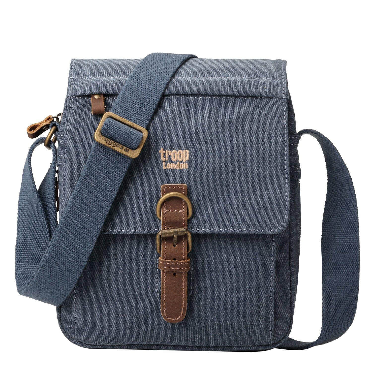 Medium stonewashed canvas crossbody bag with front organiser pocket, genuine leather trim, and brass hardware.