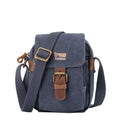 Mini canvas crossbody travel bag with adjustable strap and leather trimmed front buckle detail