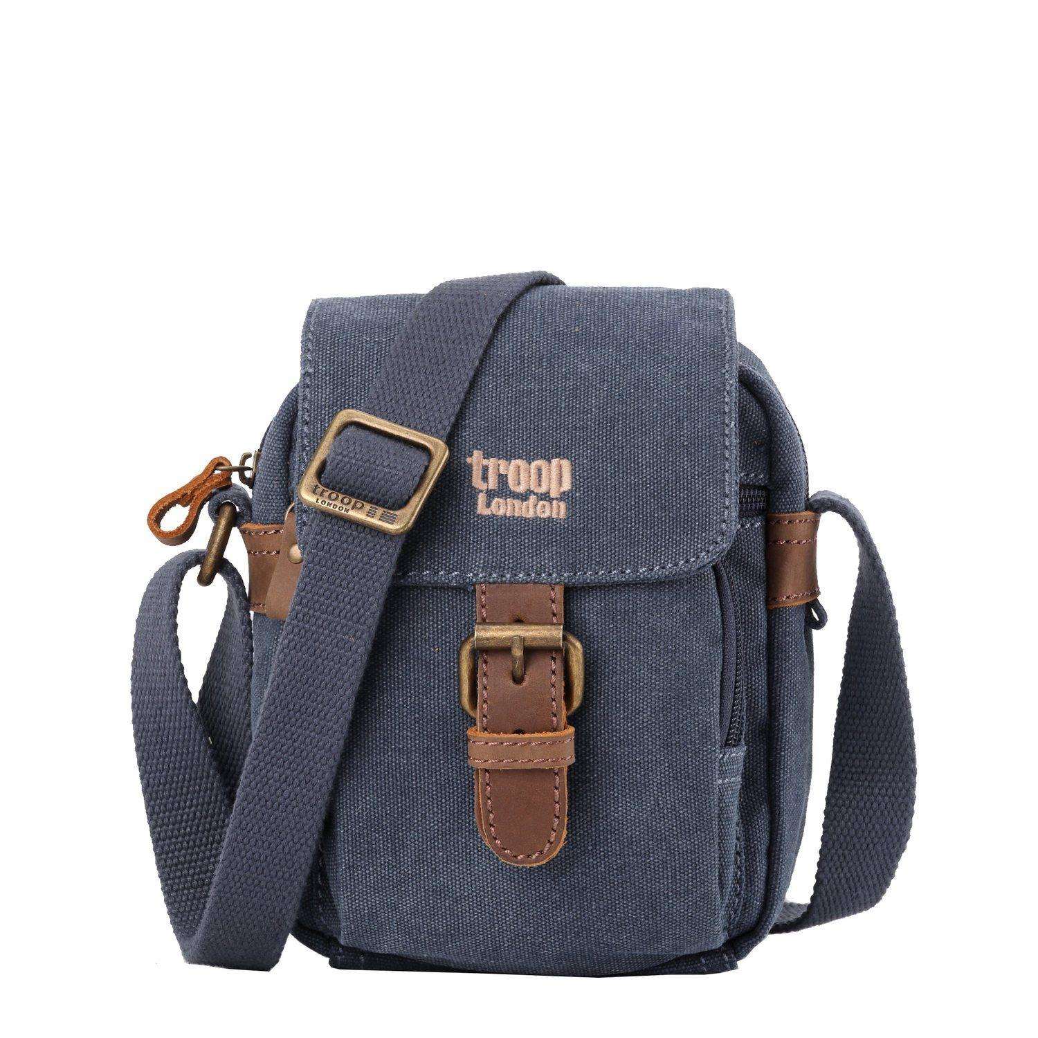 Mini canvas crossbody travel bag with adjustable strap and leather trimmed front buckle detail