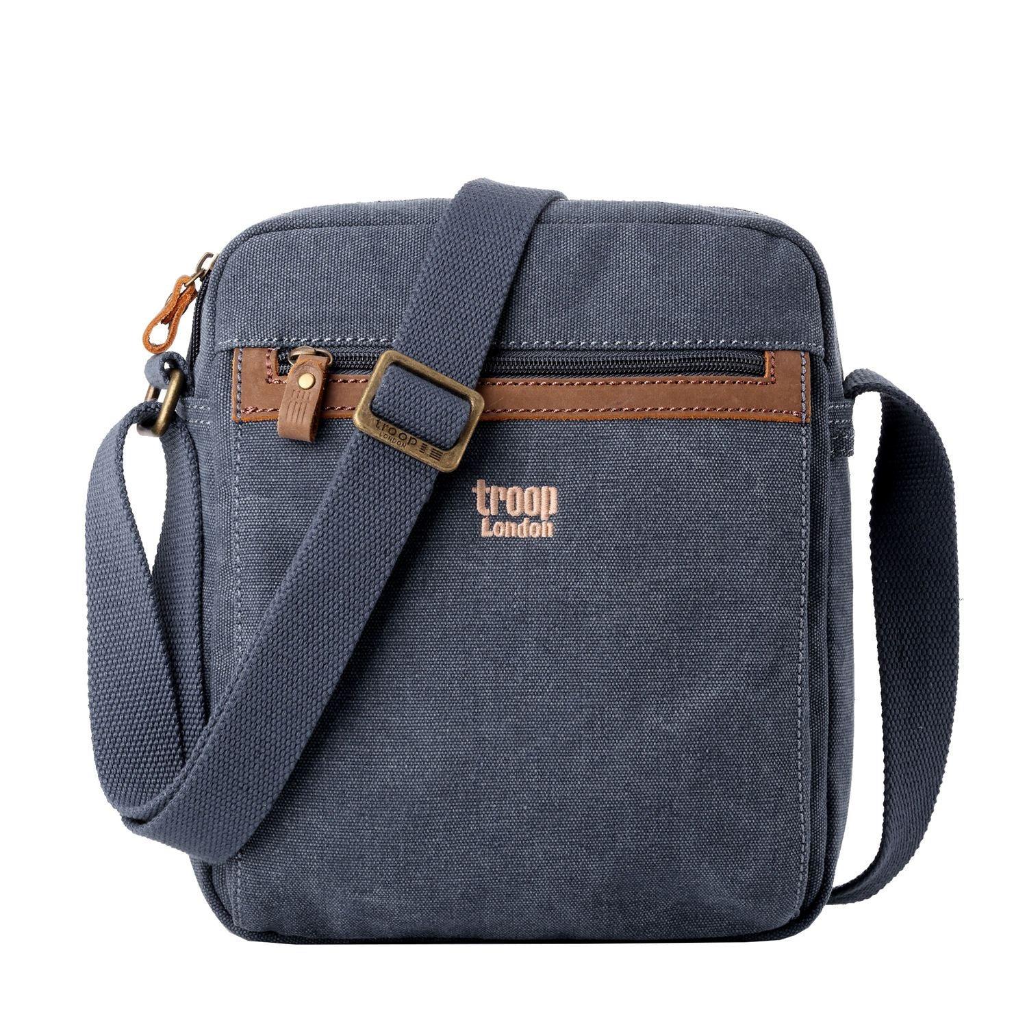 Classic stonewashed canvas crossbody bag with adjustable shoulder strap, brass buckles, and multiple zip pockets.