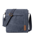Large canvas flap crossbody bag in stonewashed material with brass buckles and adjustable shoulder strap