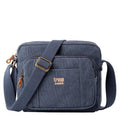 Small stonewashed canvas crossbody bag with genuine leather trimmings and adjustable shoulder strap