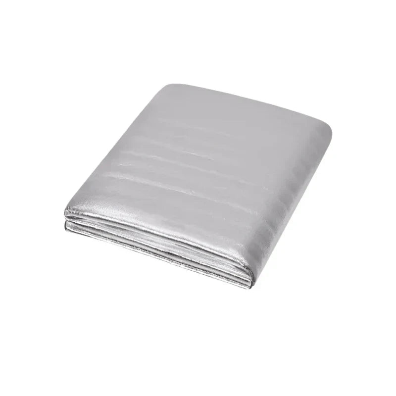 Waterproof silver aluminum outdoor picnic mat folded compactly next to its convenient portable storage bag