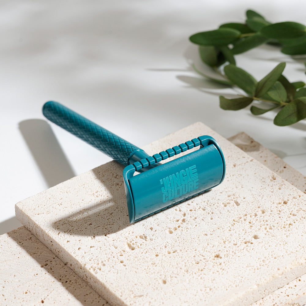 Textured diamond grip metal safety razor with ten replacement blades on a bathroom counter — view 3