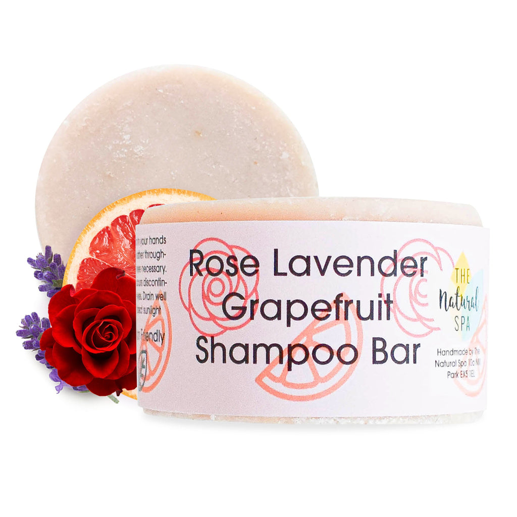 Solid rose lavender and grapefruit shampoo bar beside natural ingredients and plastic free packaging — view 2