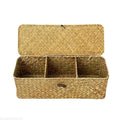 Natural handwoven seagrass storage basket with three compartments and matching lid in whitewashed yellow finish.
