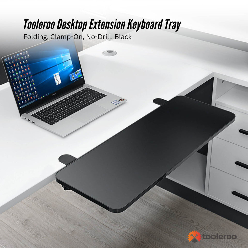 Black folding clamp-on desk extension tray with steel mounts attached to a wooden desk — view 2