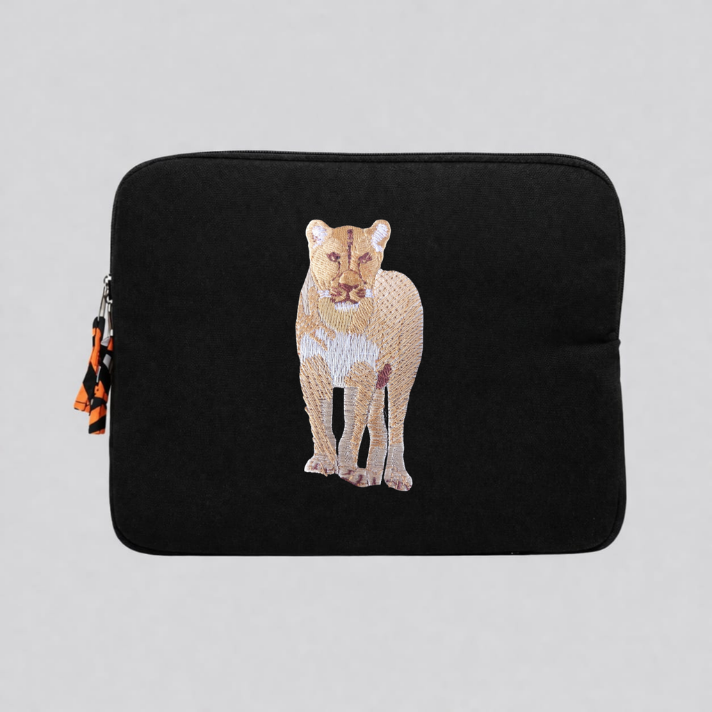 Lion laptop sleeve in handmade cotton canvas with intricate wildlife embroidery and protective padding.