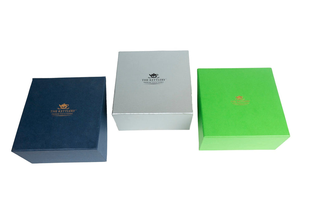 Twin tea gift set featuring two airtight storage tins and a stainless steel stick infuser.