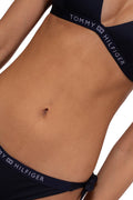 Red women's triangle bikini top with navy blue logo underbust band and halter neck laces
