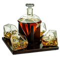 Diamond whiskey decanter set with four tasting glasses resting on an elegant mahogany wooden base