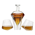 Diamond shaped glass whiskey decanter on a clear base with two matching diamond glasses.
