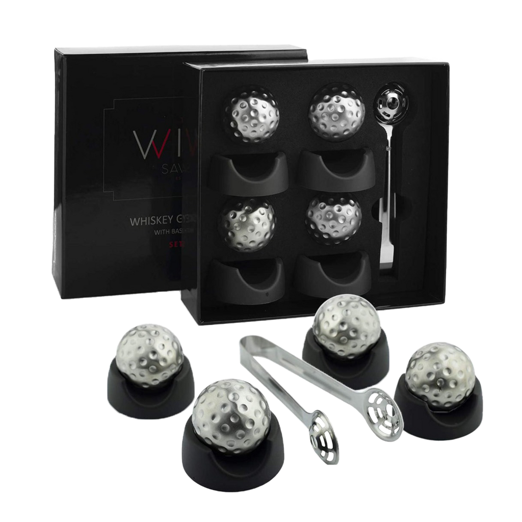 Stainless steel golf ball shaped whiskey stones chilling in a crystal glass of bourbon — view 2