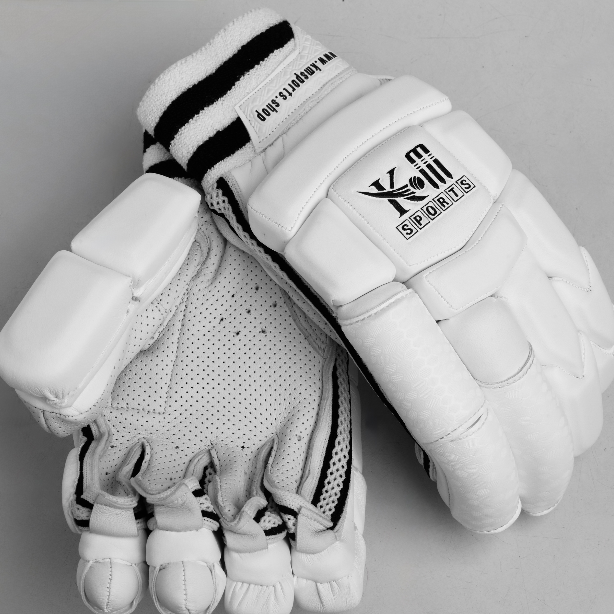 White leather cricket batting gloves with breathable mesh and padded fingers for impact protection — view 2