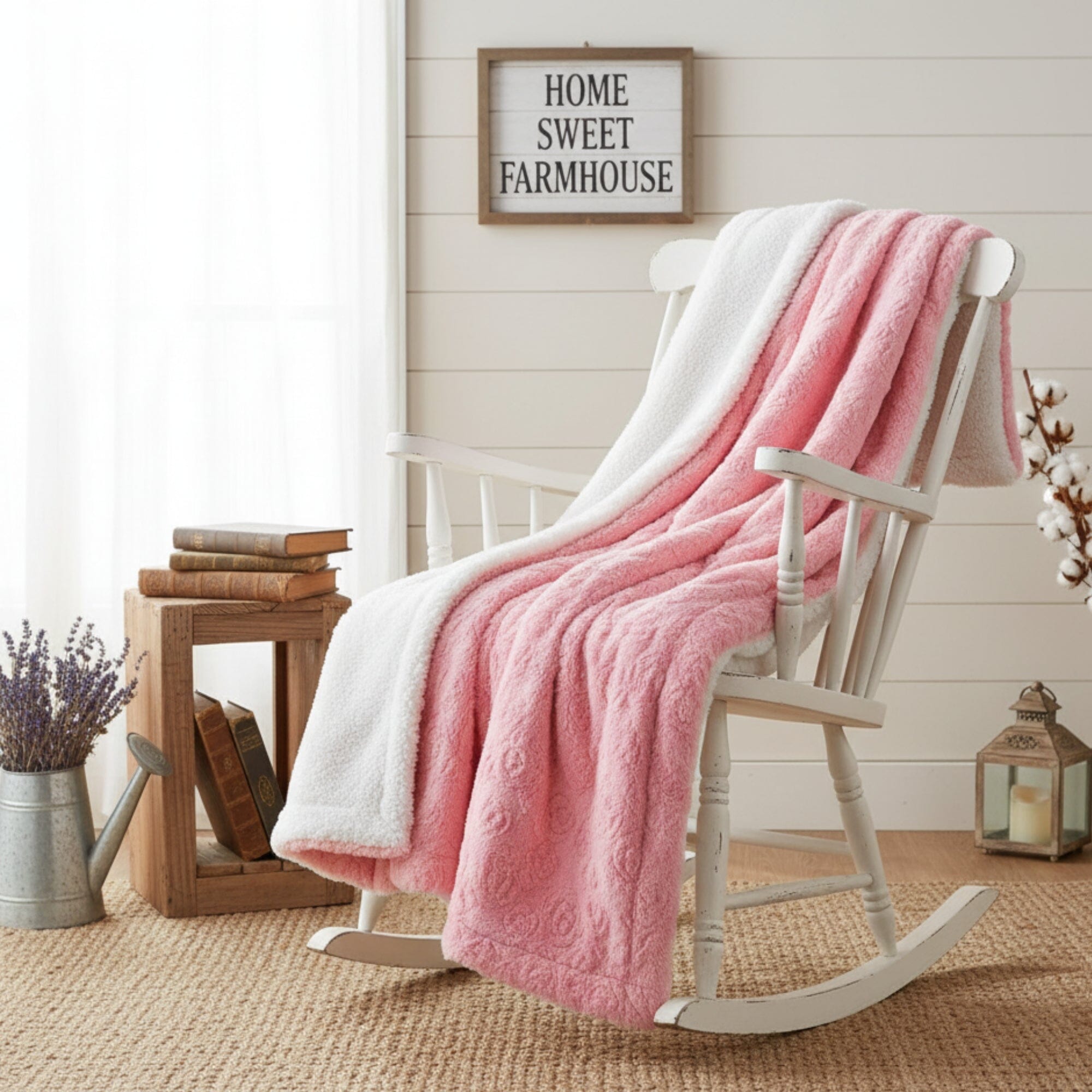 Folded baby pink faux fur throw blanket with embossed rose buds and white sherpa lining