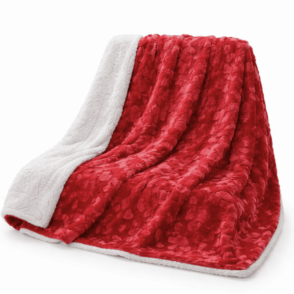Red faux fur throw blanket with embossed hearts and fluffy white sherpa backing draped on couch — view 4