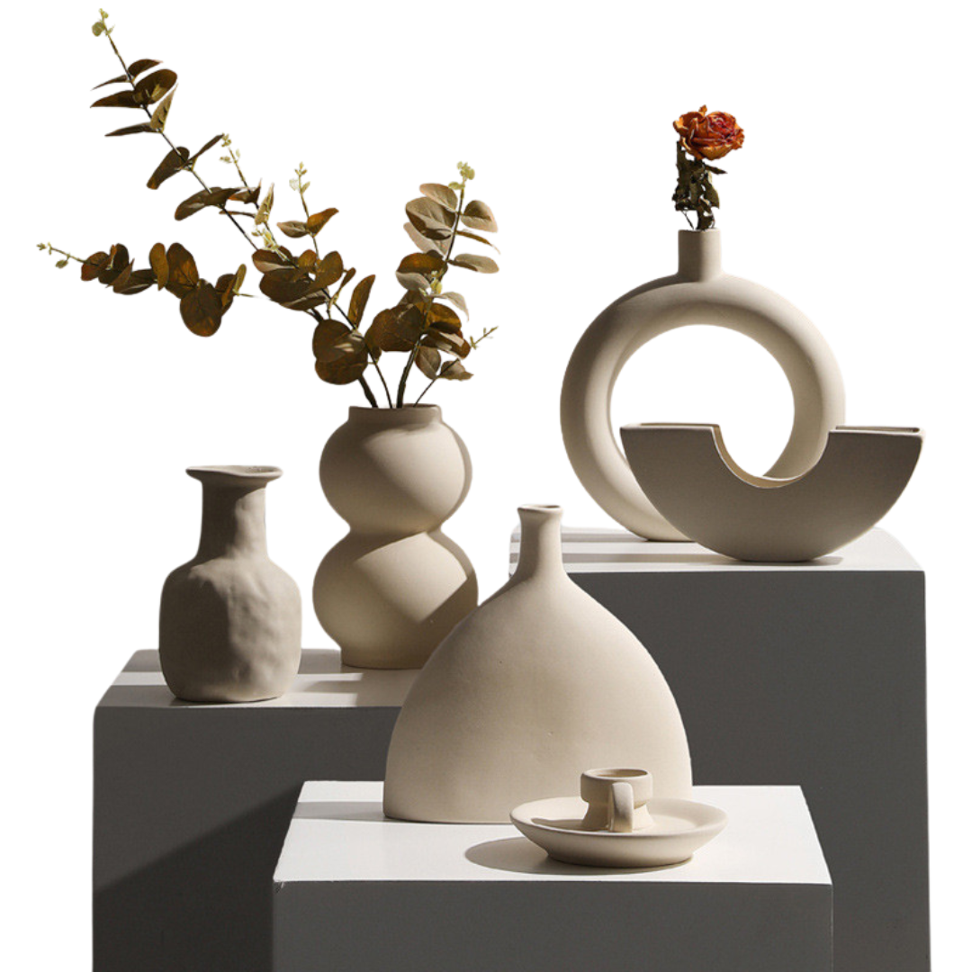 Modern minimalist taupe ceramic vase and candle holder decor pieces for dried floral arrangements.
