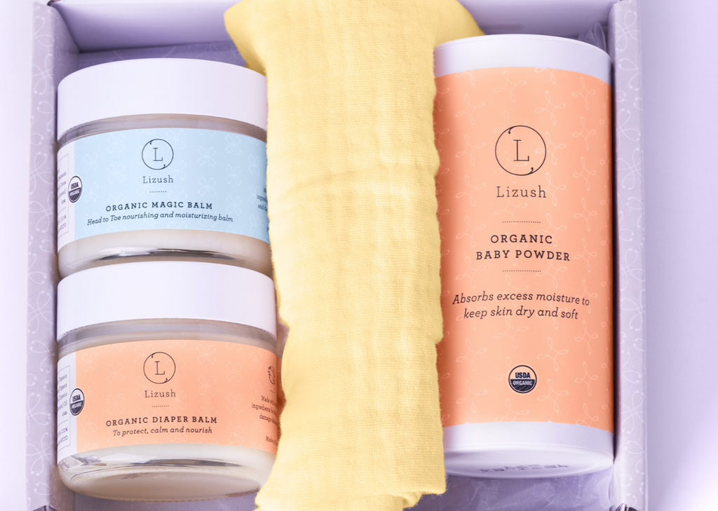 Organic new baby gift set in box with natural diaper balm, baby powder, and bib — view 4