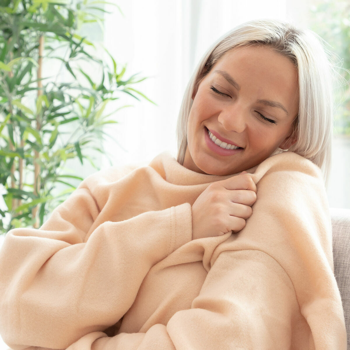 Soft wearable single sleeved blanket with a large central pocket for cozy winter lounging — view 2