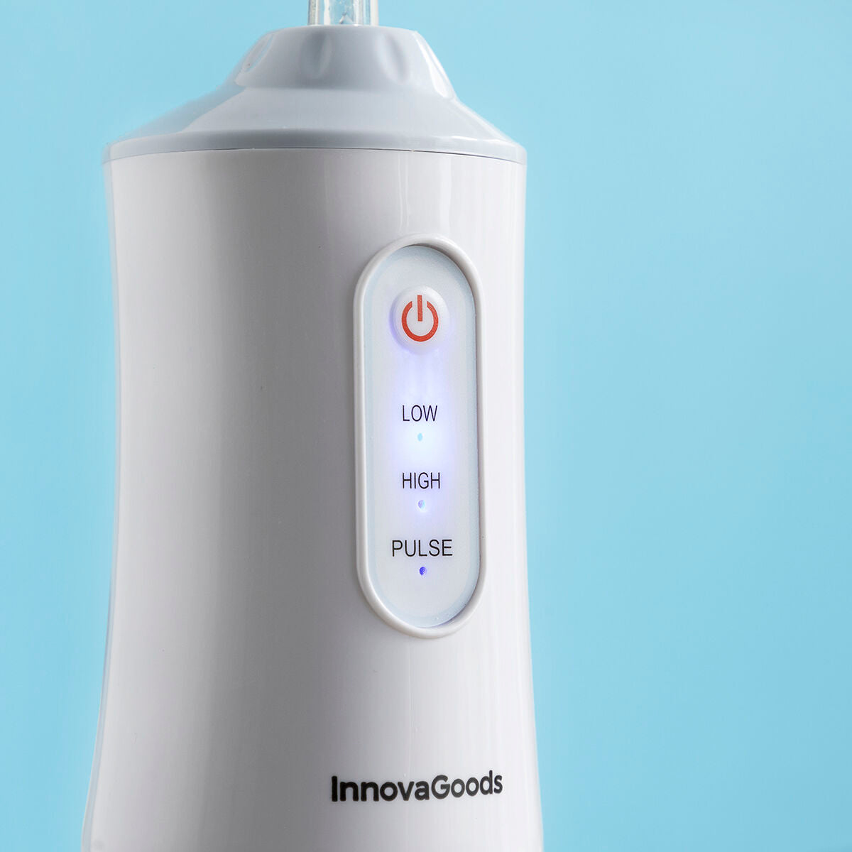 Portable blue and white cordless water flosser with interchangeable cleaning heads and USB cable. — view 9