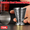 Stainless steel cocktail jigger measuring cup with silver mirror finish on a plain background