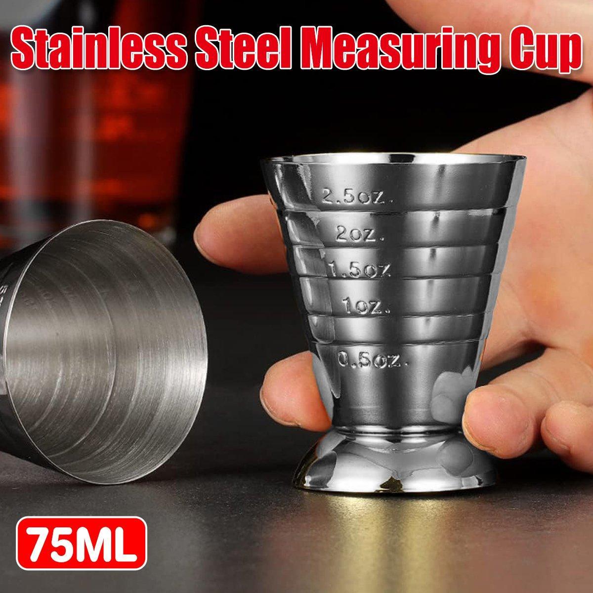 Stainless steel cocktail jigger measuring cup with silver mirror finish on a plain background