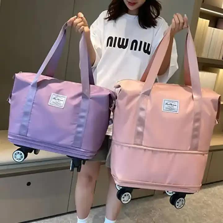 Purple large capacity foldable rolling travel duffel bag with wheels and durable waterproof fabric. — view 4