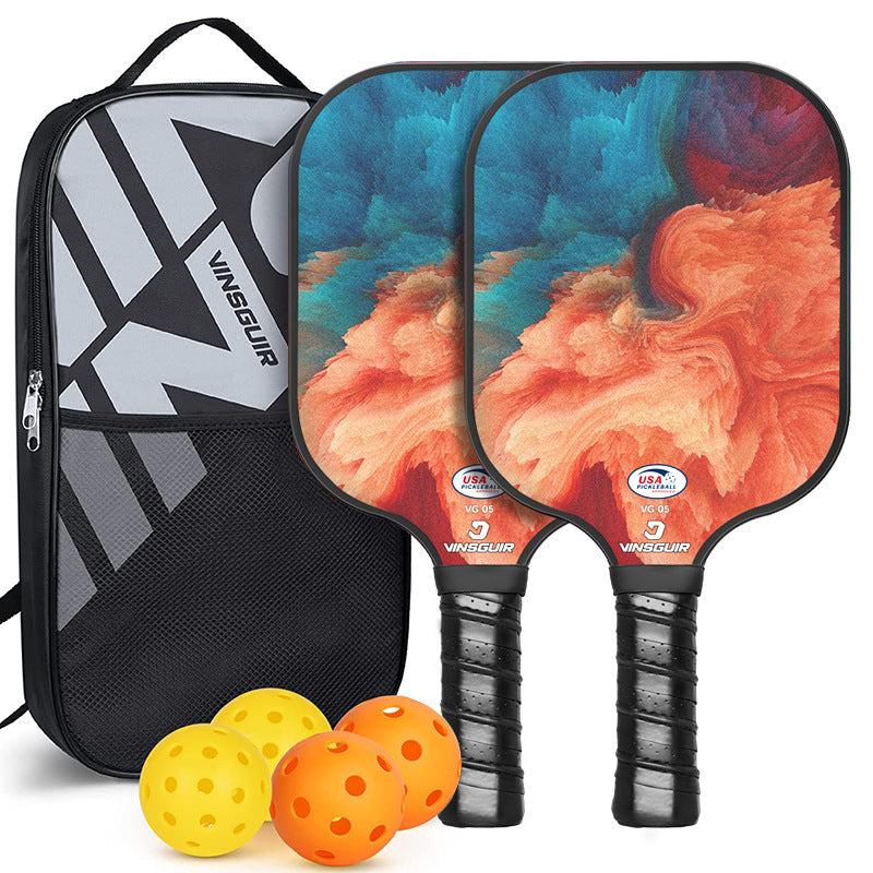Vintage fiberglass pickleball paddle set with retro graphics, four balls, and black storage bag