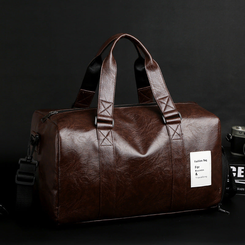 Brown PU leather men's gym and travel duffel bag with detachable shoulder strap and side handles
