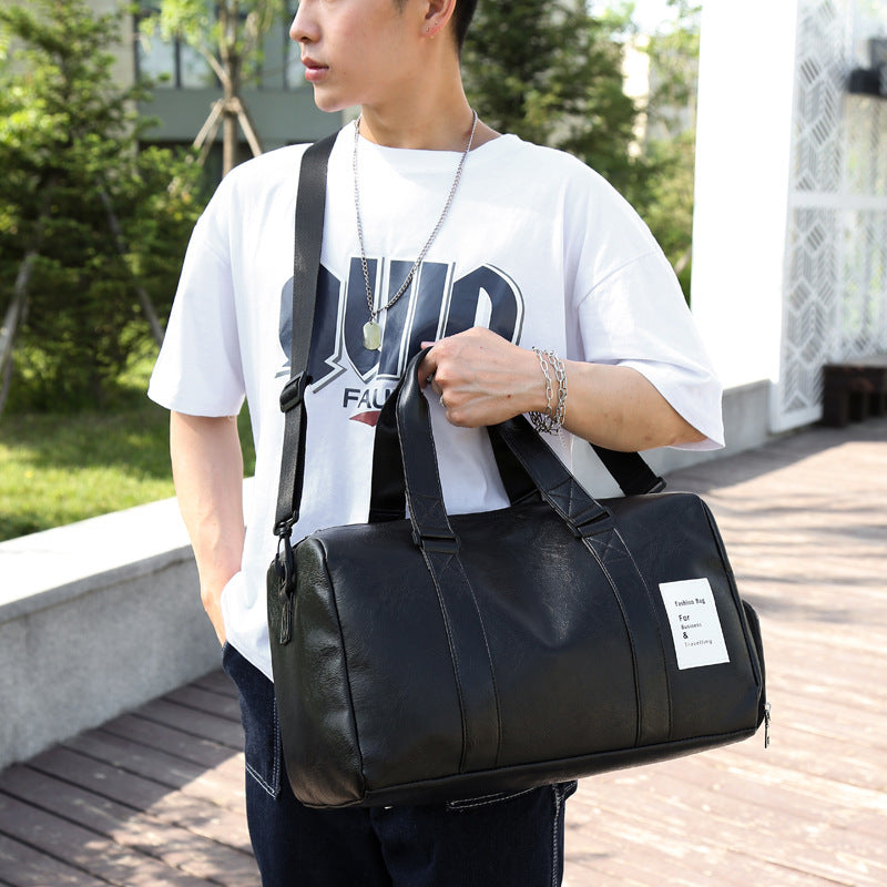 Brown PU leather men's gym and travel duffel bag with detachable shoulder strap and side handles — view 2