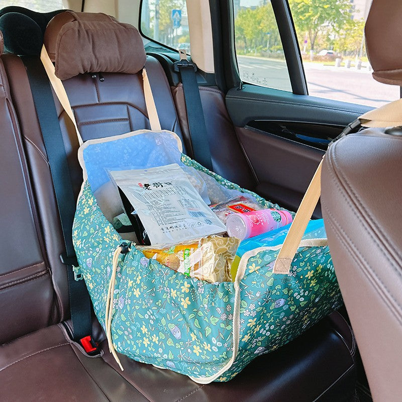 Green car back seat organizer hammock made of durable polyester holding travel essentials and travel essentials